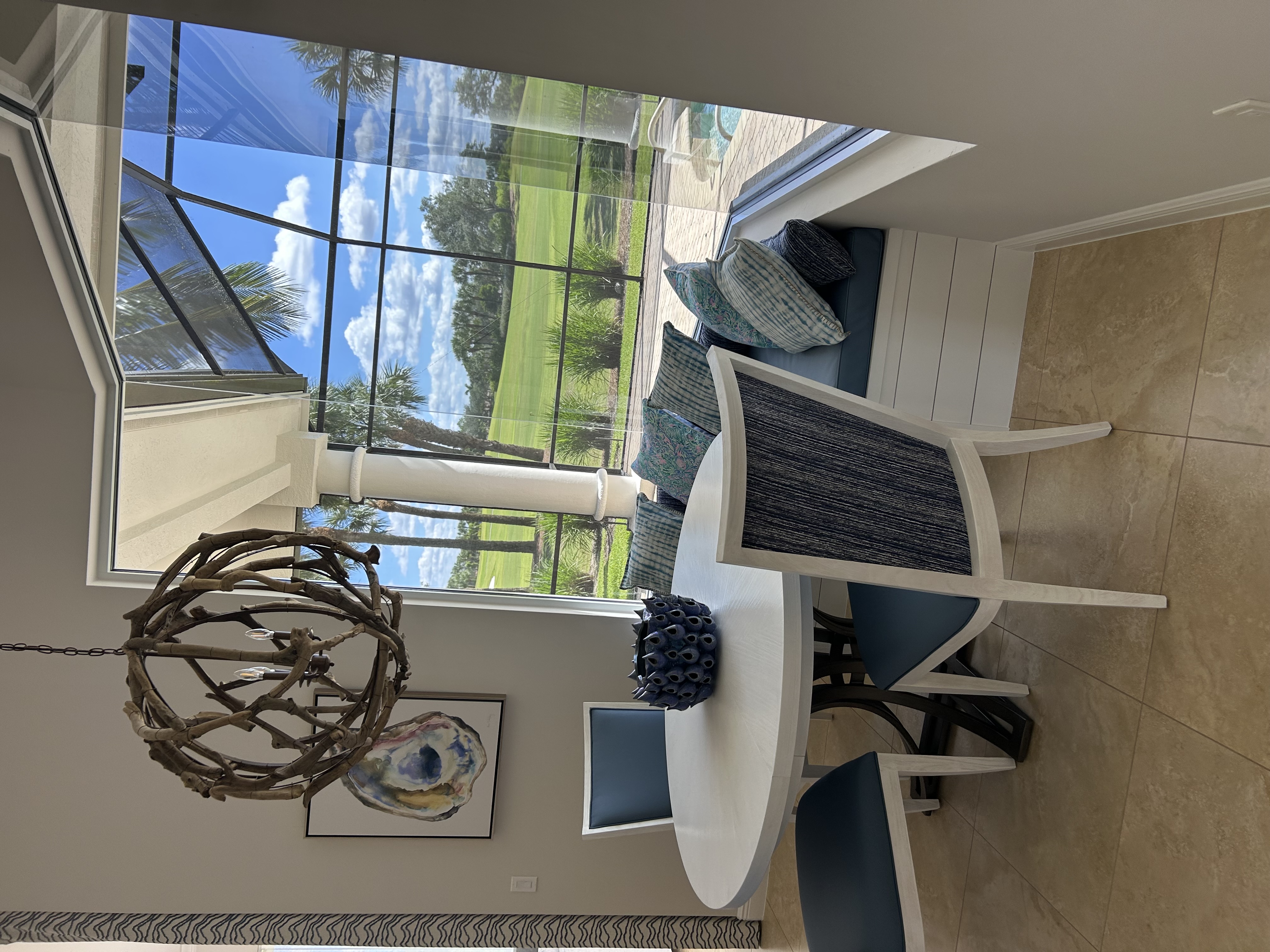 Contemporary dining area with golf course view in a Talis Park home, Naples FL